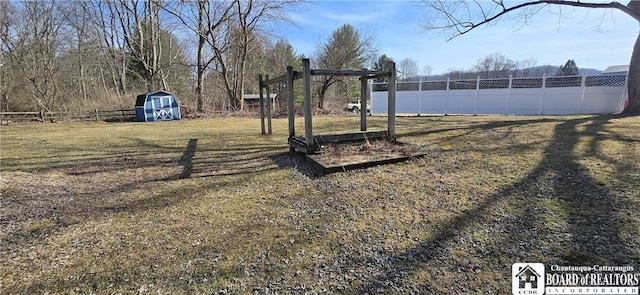 1620 Haskell Rd, Portville, NY 14760 - view of yard featuring a storage unit, an outdoor structure, and a fenced backyard