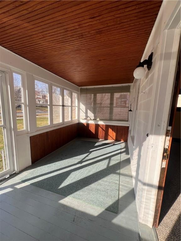 sunroom featuring wood ceiling