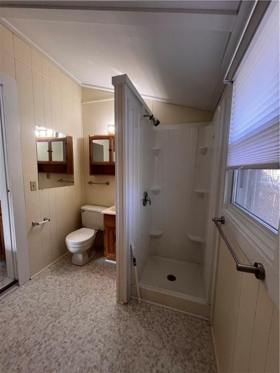 full bath with wooden walls, a shower stall, vanity, and toilet