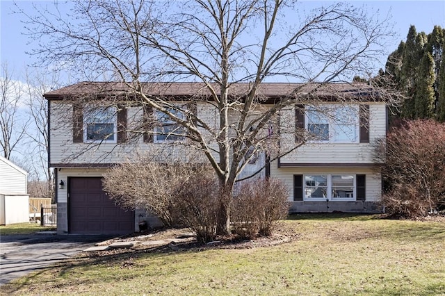 view of front of home with driveway, a front lawn, and a garage