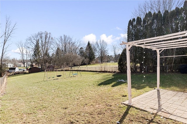 view of yard with a patio, a playground, and fence