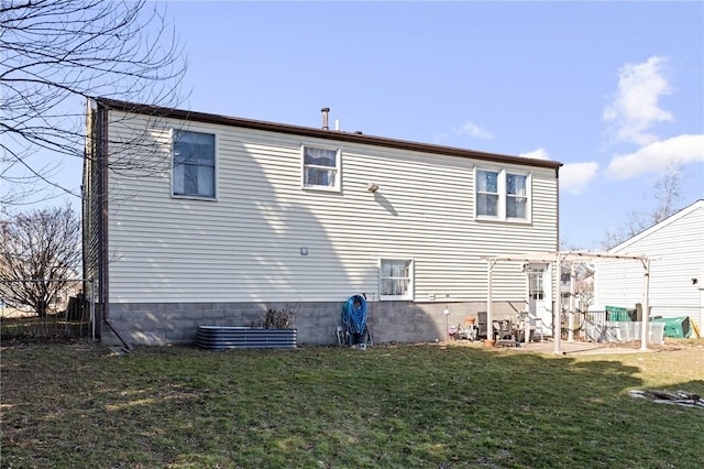 back of house with a patio and a yard