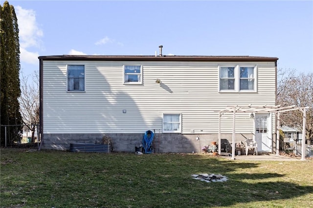 rear view of property with a yard and fence