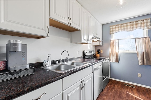 kitchen with visible vents, a sink, under cabinet range hood, white cabinetry, and appliances with stainless steel finishes