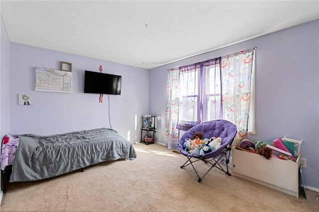 carpeted bedroom with baseboards