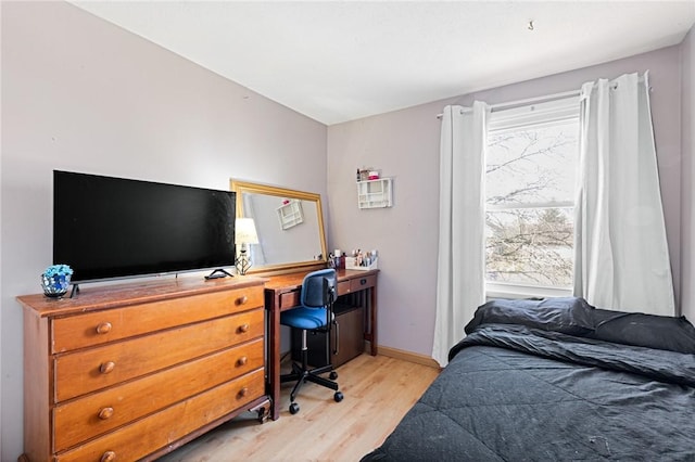 bedroom with baseboards and light wood-style floors