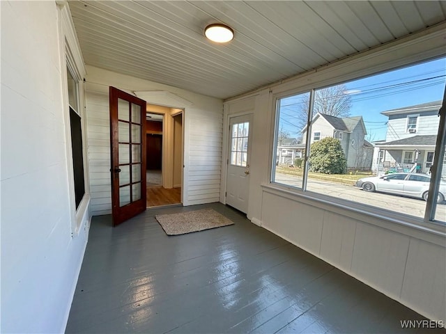 unfurnished sunroom with french doors