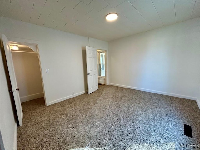 unfurnished bedroom featuring baseboards and carpet