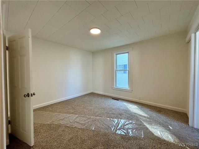 spare room with visible vents and baseboards