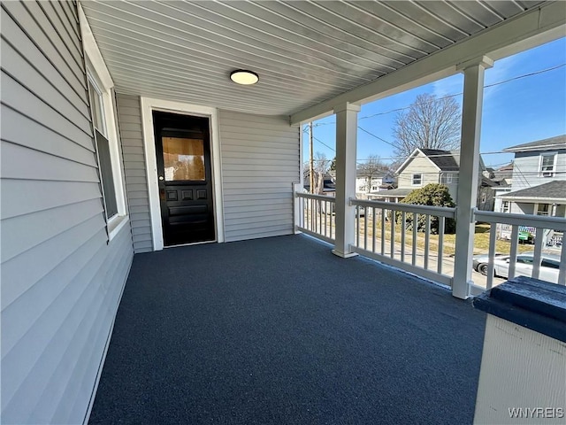 view of patio with a residential view and a balcony