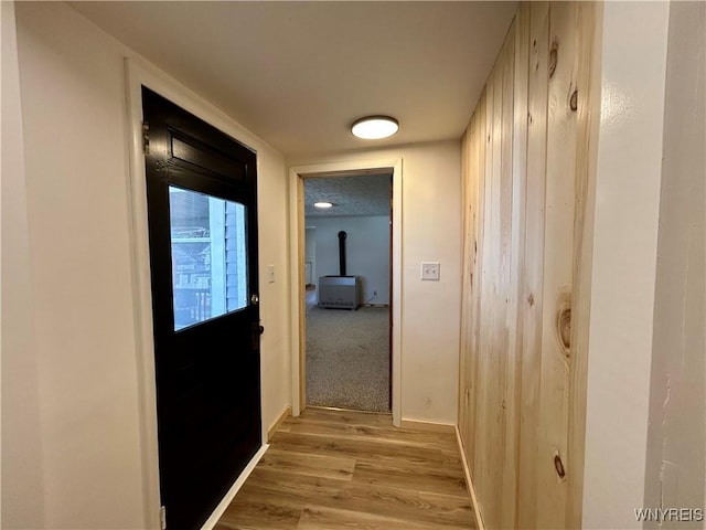 hallway featuring light wood-style floors and baseboards