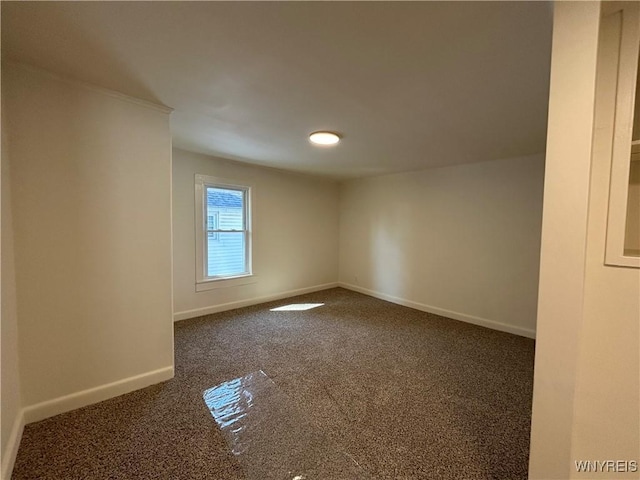 unfurnished room with baseboards and carpet floors