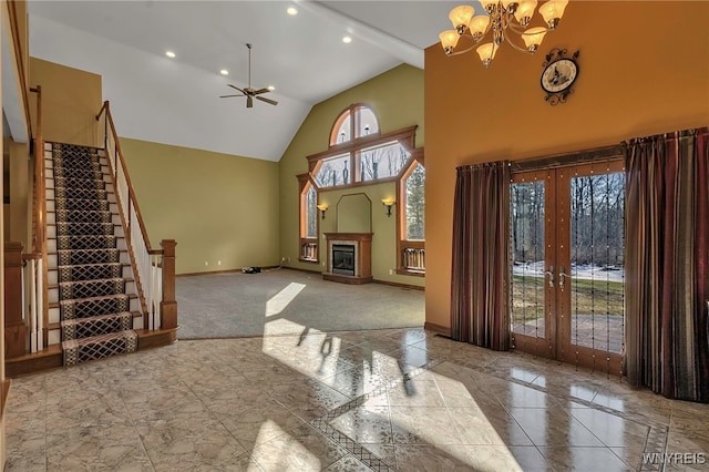 living area featuring high vaulted ceiling, marble finish floor, french doors, baseboards, and stairs