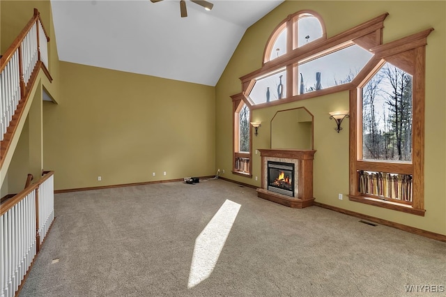 living area with visible vents, high vaulted ceiling, carpet floors, baseboards, and ceiling fan