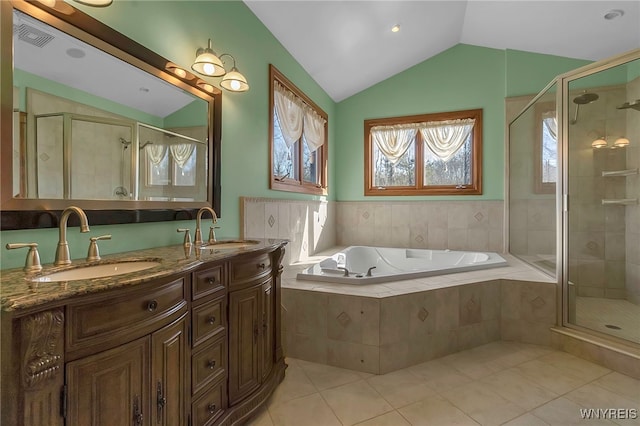 bathroom with a sink, a garden tub, a stall shower, and vaulted ceiling