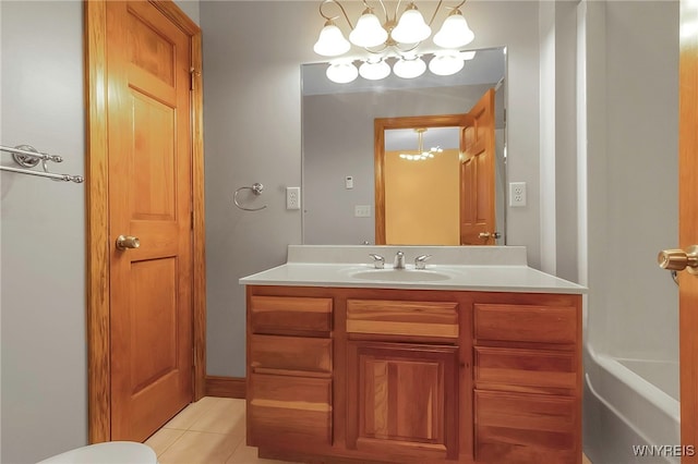 bathroom with a chandelier, tile patterned flooring, and vanity