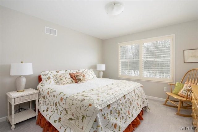 carpeted bedroom with visible vents and baseboards