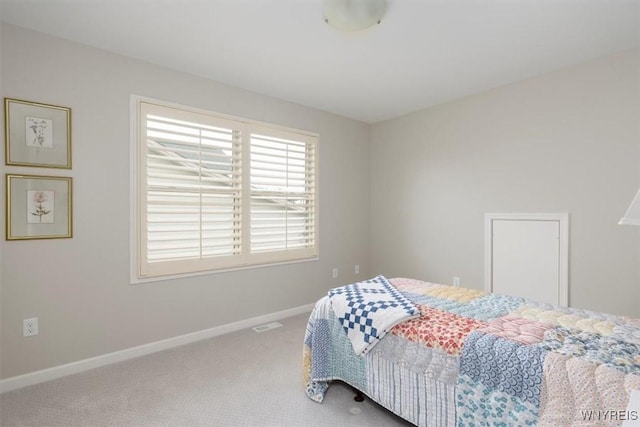 bedroom featuring baseboards and carpet