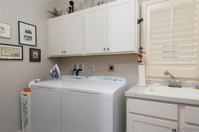 laundry room with a sink, cabinet space, and washing machine and clothes dryer