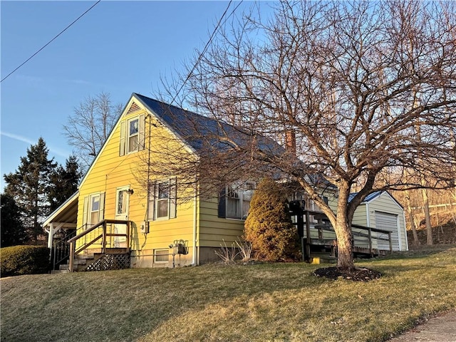 view of front of house with a front yard and an outdoor structure