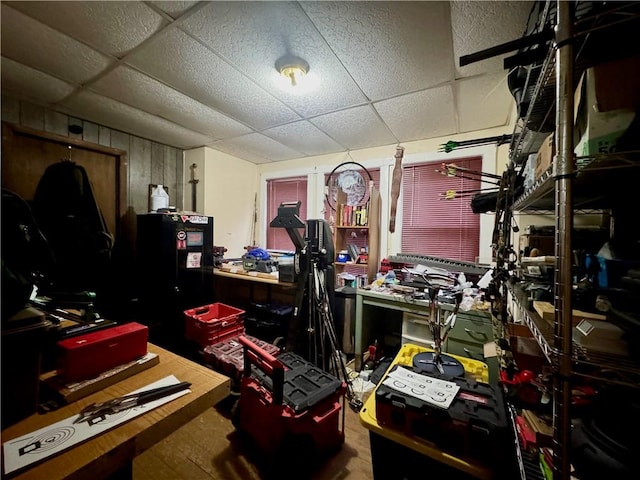 office with a drop ceiling and a workshop area