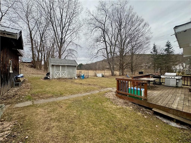 view of yard with a storage unit, a deck, and an outdoor structure