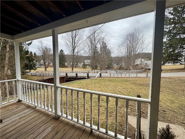 wooden deck with a yard and a porch