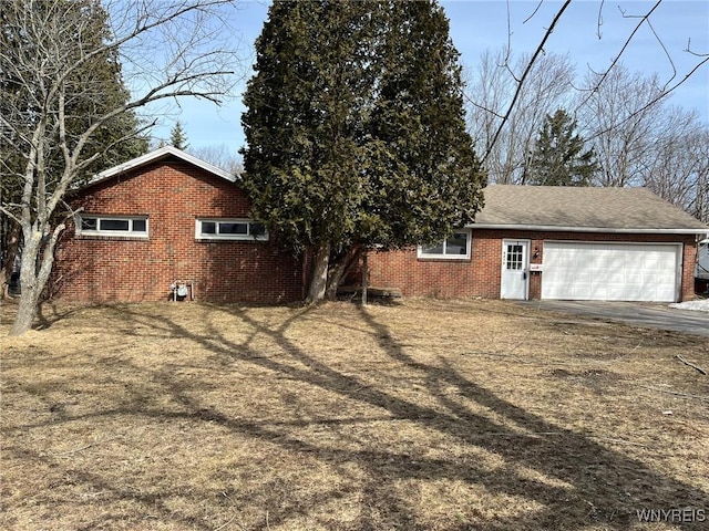 view of side of home with brick siding and an attached garage