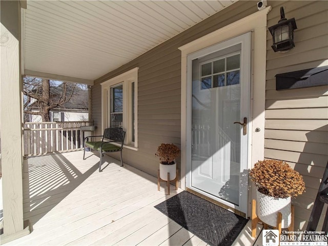 view of exterior entry with covered porch