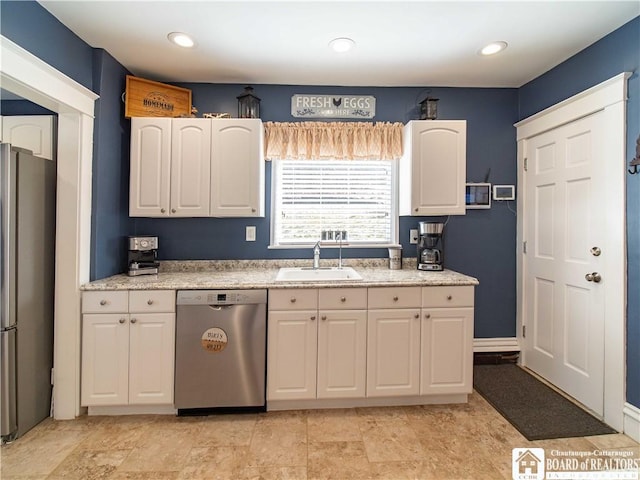 kitchen featuring a sink, stainless steel appliances, recessed lighting, and white cabinetry