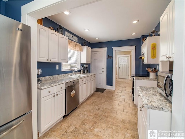 kitchen featuring recessed lighting, stainless steel appliances, and white cabinets