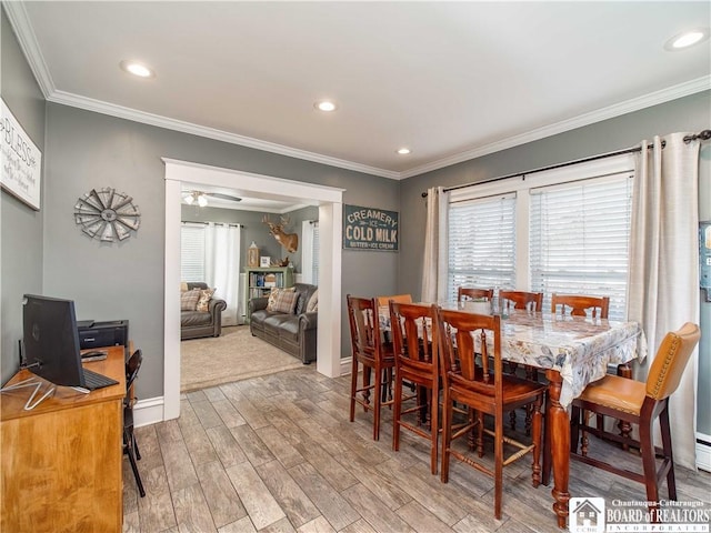 dining area featuring recessed lighting, baseboards, wood finished floors, and crown molding