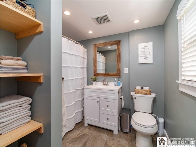 bathroom with vanity, toilet, recessed lighting, and visible vents