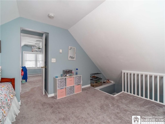 interior space featuring a baseboard heating unit, vaulted ceiling, and baseboards