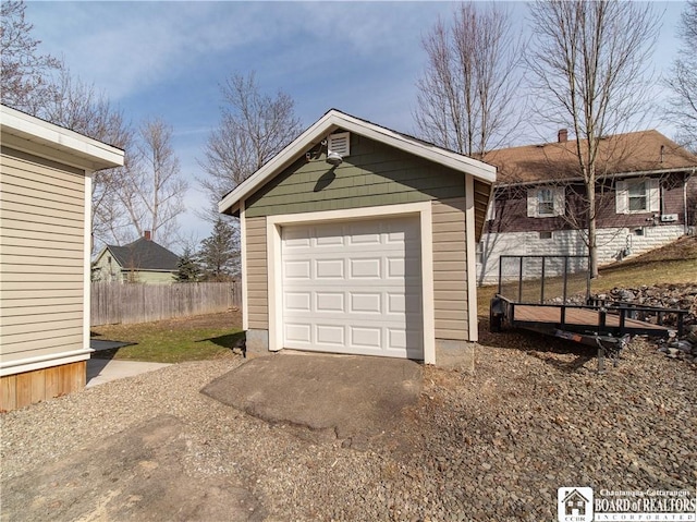 detached garage with driveway and fence