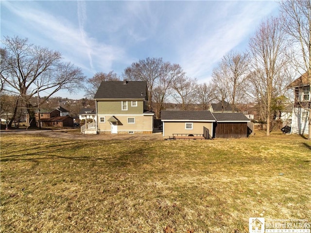 rear view of property with a lawn