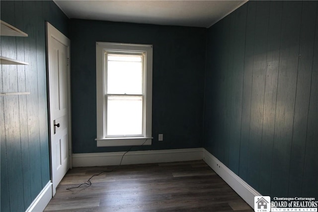 empty room featuring baseboards and wood finished floors