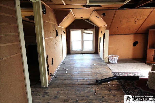 interior space featuring wood-type flooring and vaulted ceiling