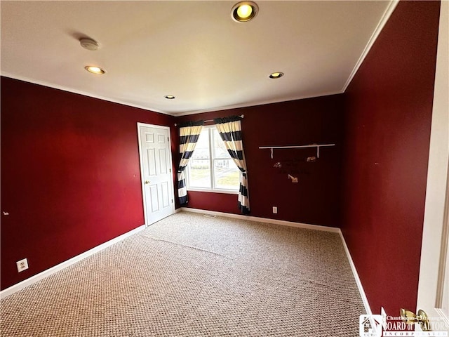 spare room with crown molding, recessed lighting, light colored carpet, and baseboards