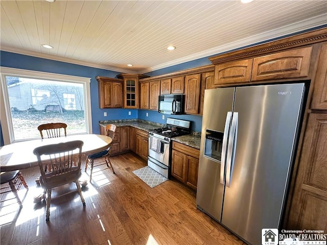 kitchen with crown molding, wood ceiling, appliances with stainless steel finishes, wood finished floors, and brown cabinetry