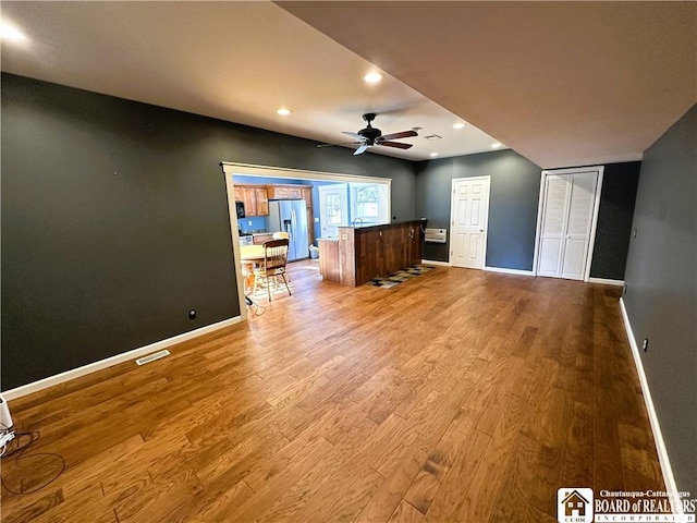 interior space featuring visible vents, wood finished floors, recessed lighting, baseboards, and ceiling fan