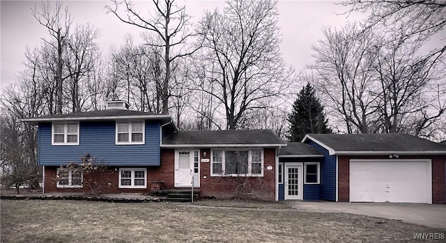 tri-level home with brick siding, a chimney, concrete driveway, and an attached garage