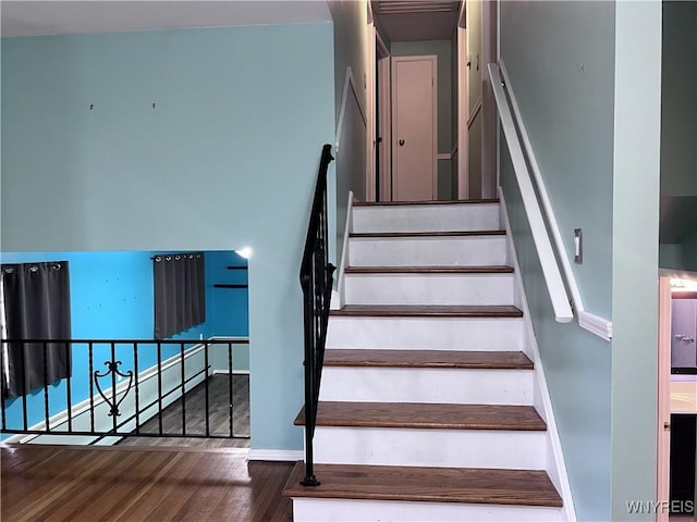 stairs with baseboards and wood finished floors