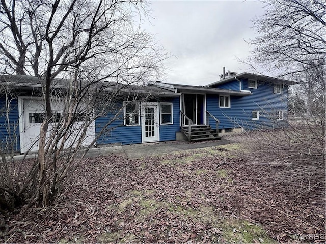 rear view of house with entry steps