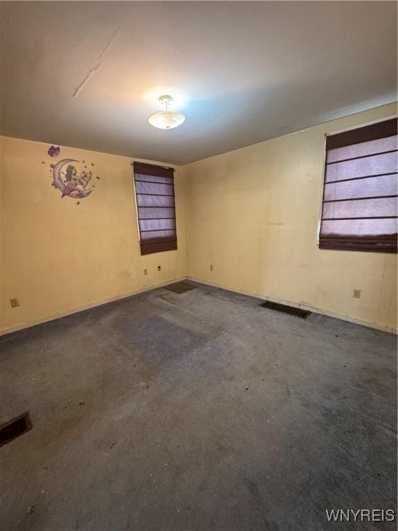 unfurnished room with visible vents and concrete flooring