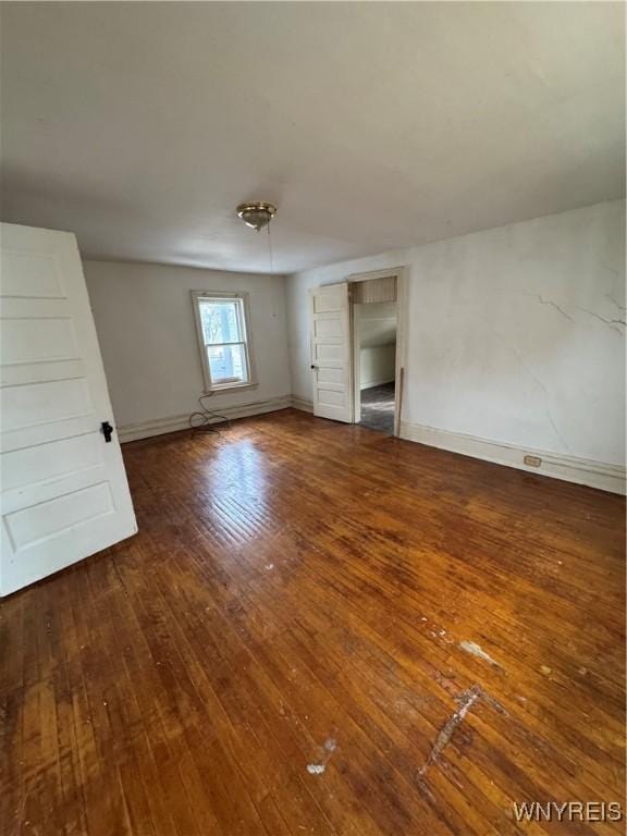 interior space featuring baseboards and hardwood / wood-style flooring