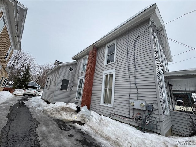 view of snow covered exterior featuring a garage