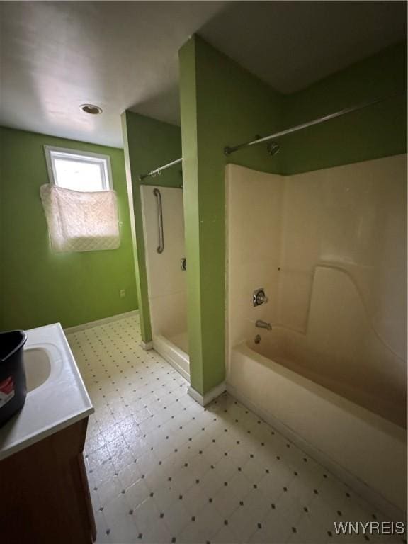 full bathroom featuring vanity, tile patterned floors, shower / tub combination, and baseboards