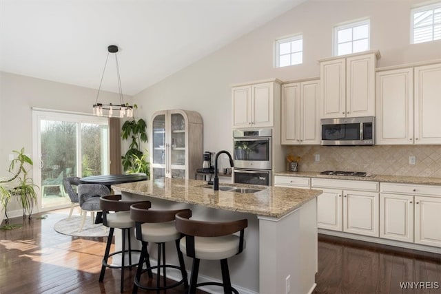 kitchen featuring decorative backsplash, a healthy amount of sunlight, and stainless steel appliances