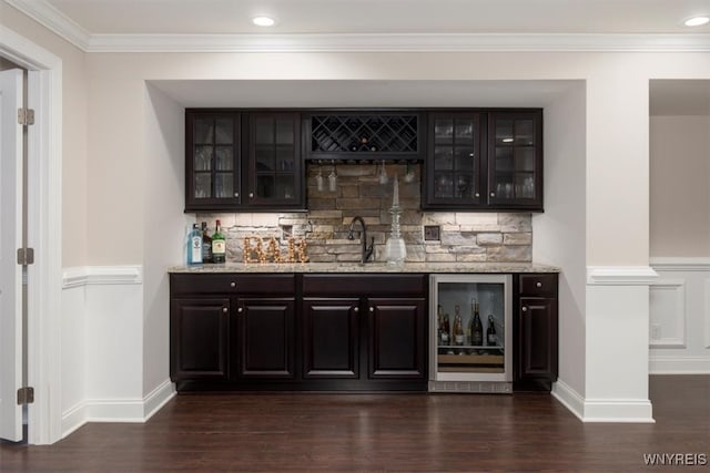 bar featuring dark wood-style floors, beverage cooler, a sink, indoor wet bar, and tasteful backsplash